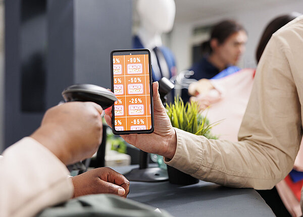 App-Rabatte Coupon-Marken auf einem Smartphone werden an der Kasse abgescannt